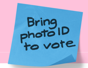 Large post it note that says Bring photo ID to vote