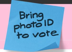 Large post it note with words Bring photo ID to vote