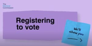 Sign saying Registering to vote along with blue post it note to say We will show you and an arrow to the right.