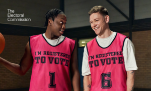 Two basketball players with bibs that say I am registered to vote.